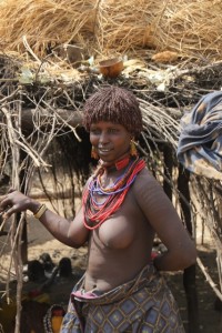 Karo woman in front of her house