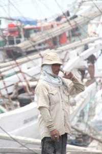 dock worker giving detailed hand instructions during the loading