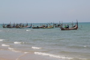 fishing boats in front of the beach