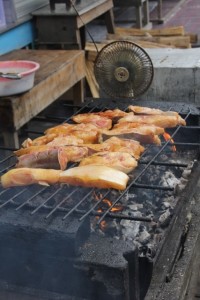 fish being grilled, note the little fan to blow the charcoal