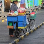 women selling from their bicycles on the main board walk of Muara Muntai