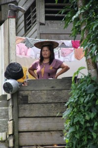 one of the villagers observes the river activities from her balcony