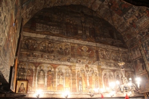 on of the walls completely covered with frescoes