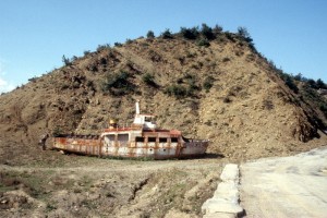 a stranded boat, from the days the water level in the lake behind the hydroelectric dam in the Devoll river was much higher