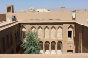 a courtyard seen from a roof: what else is hidden behind the high walls of Yazd?