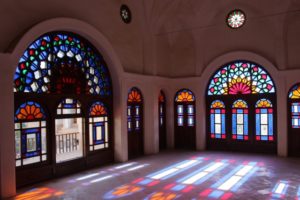 large room, decorated with stained glass reflecting on the floor, in the Khan-e Tabatabei