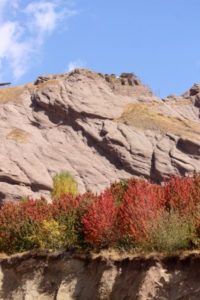 the Alamut Castle high up, behind the autumn colours