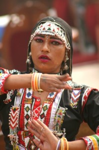 another traditionally dressed woman, dancing 