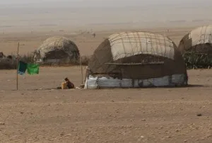 and more huts, with corrugated iron-walls