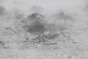 violently bubbling mud pool in the center of the crater