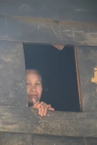 Mamasa lady spying from the window of a traditional house