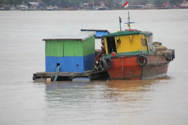 two barges in the Mahakam River outside Samarinda