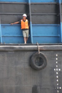 sailor on one of the coal barges on the Mahakam River
