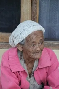 old lady enjoying the late sunlight on the verandah