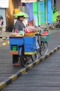 women selling from their bicycles on the main board walk of Muara Muntai