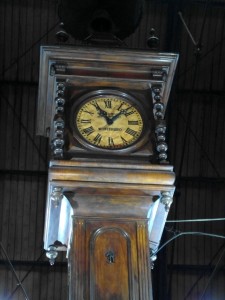 inside the market stands a huge wooden clock