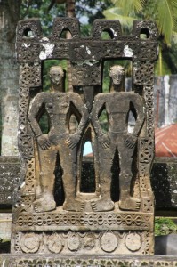 carving of a man and a woman at the village entrance