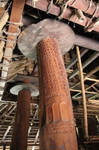 and the finely carved support poles inside the houses