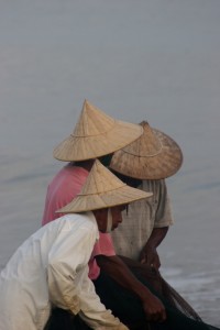 three of the fishermen working a net