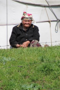 older lady in front of her yurt