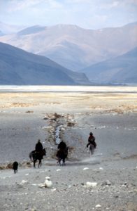 Tibetans on horseback, on the Tibetan plateau towards Nepal
