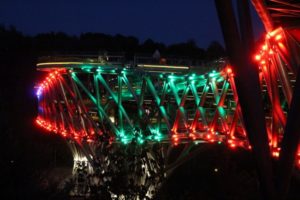 the bridge by night, lit in different and varying colours