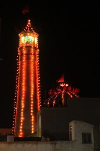 mosque decorated with lights along the minaret and the cupola