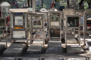 glass boxes with war memento adorn the martyrs graves